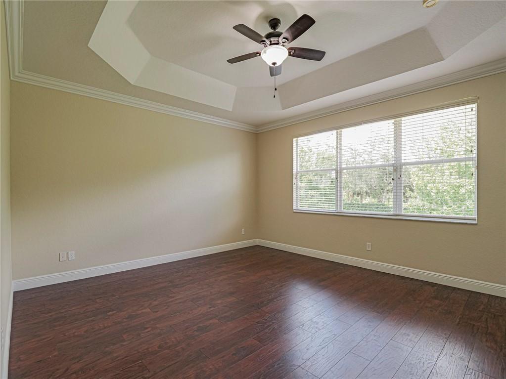 1931 Grey Falcon Circle Southwest Vero Beach, FL 32962 - Photo 14 of 36 a view of empty room with wooden floor and fan
