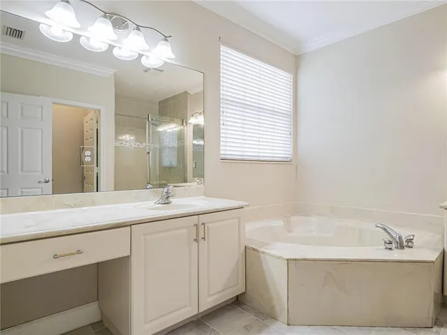 a bathroom with a sink vanity and shower