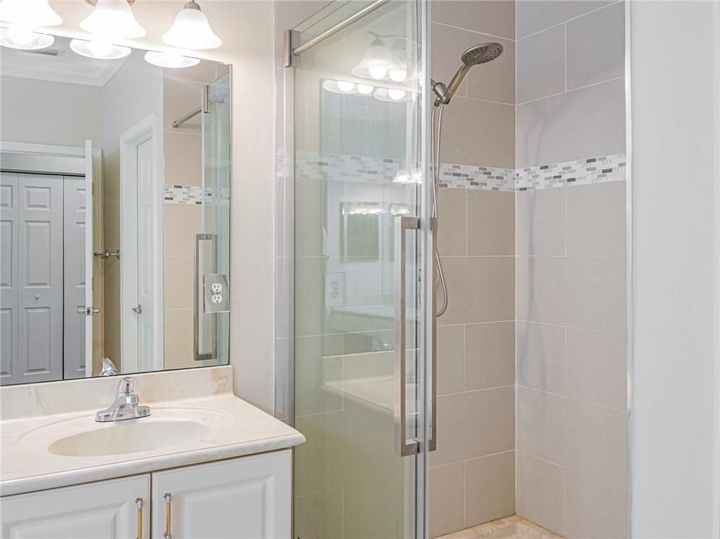 1931 Grey Falcon Circle Southwest Vero Beach, FL 32962 - Photo 17 of 36 a bathroom with a sink vanity and shower