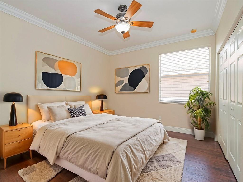 1931 Grey Falcon Circle Southwest Vero Beach, FL 32962 - Photo 19 of 36 a bedroom with a bed and a chandelier