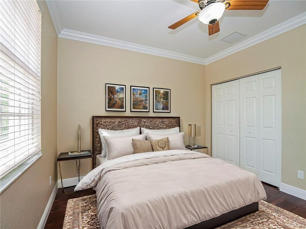 1931 Grey Falcon Circle Southwest Vero Beach, FL 32962 - Photo 23 of 36 a bedroom with a large bed and a window