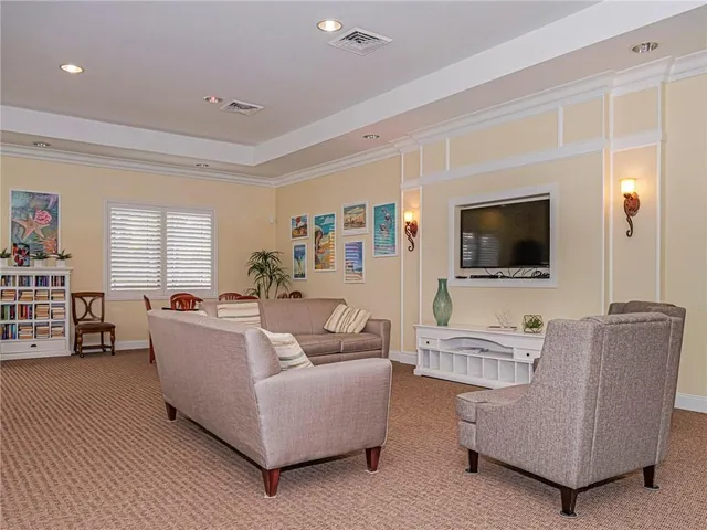a view of a house with a small yard and palm trees