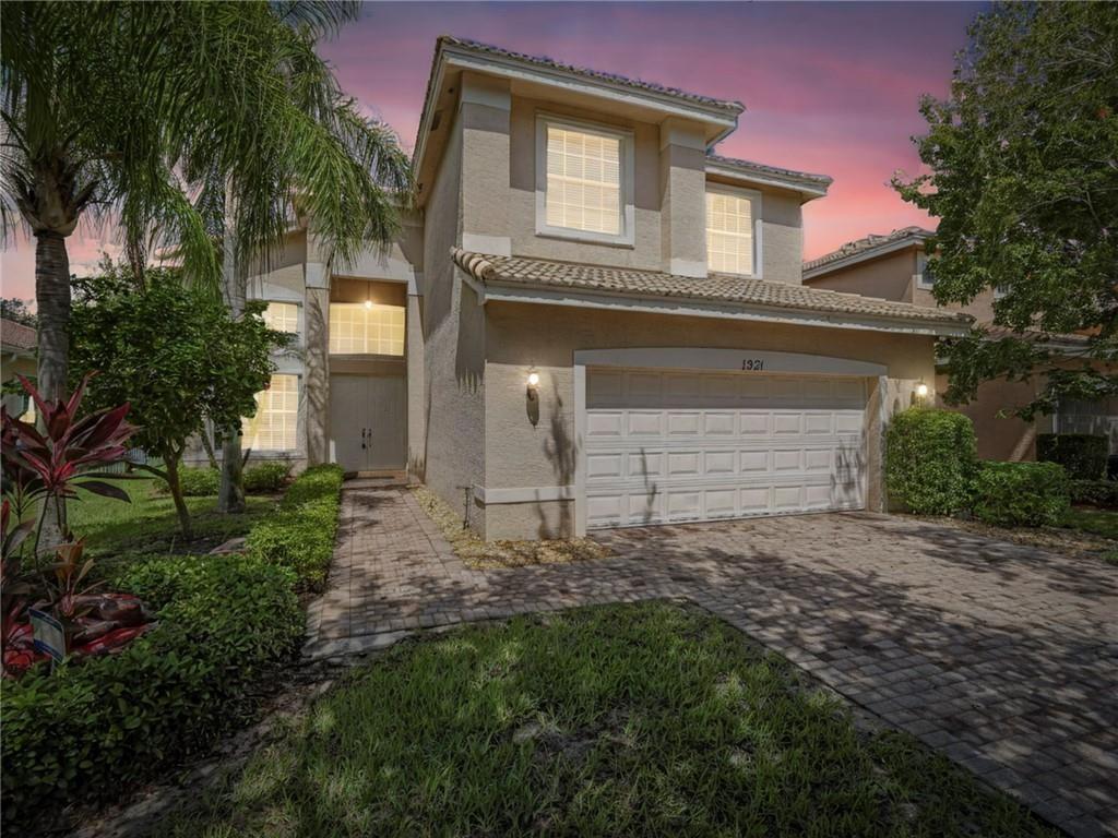 1931 Grey Falcon Circle Southwest Vero Beach, FL 32962 - Photo 35 of 36 a view of a house with a small yard and palm trees