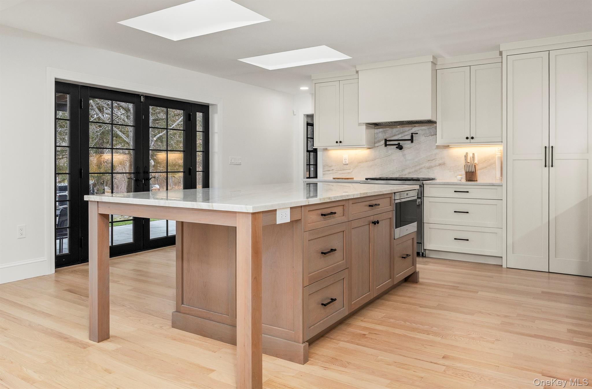 97 Valley Farm Road Millbrook, NY 12545 - Photo 20 of 50 Kitchen featuring skylights, French doors to covered patio.