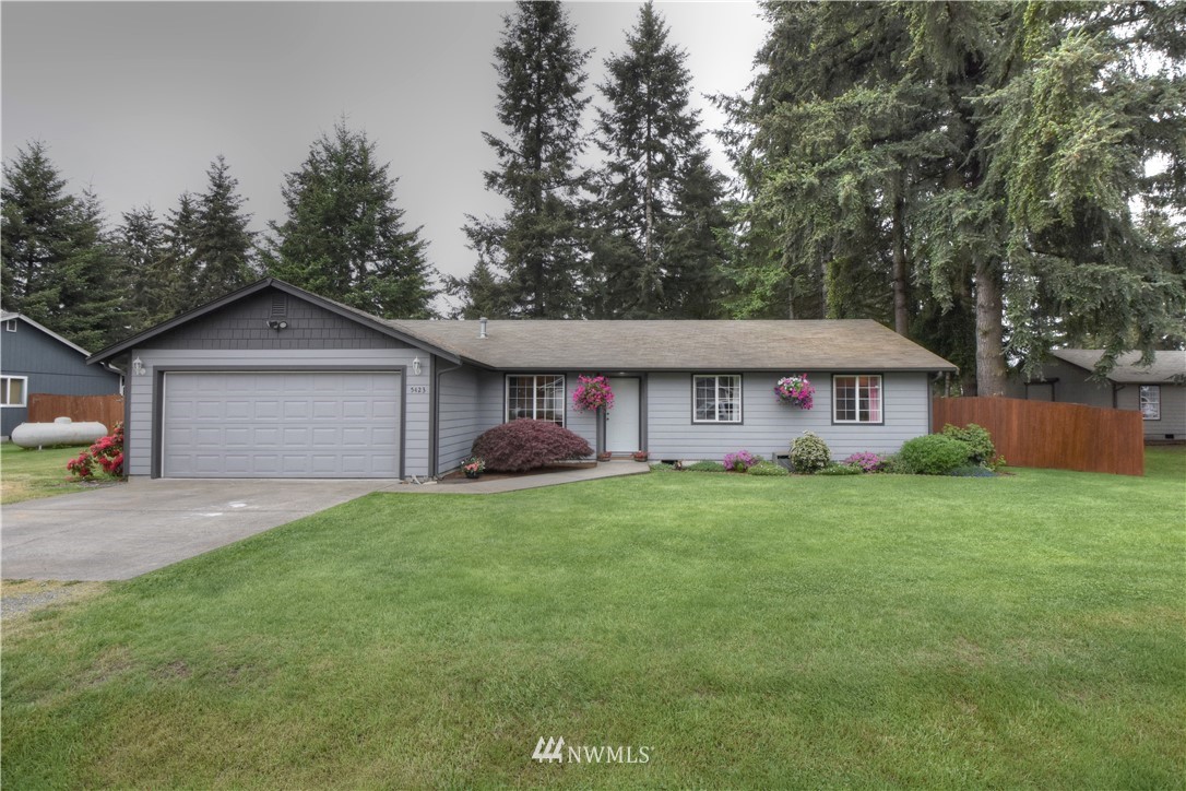 5423 187th Court Southwest Rochester, WA 98579 - Photo 1 of 24 a front view of a house with garden