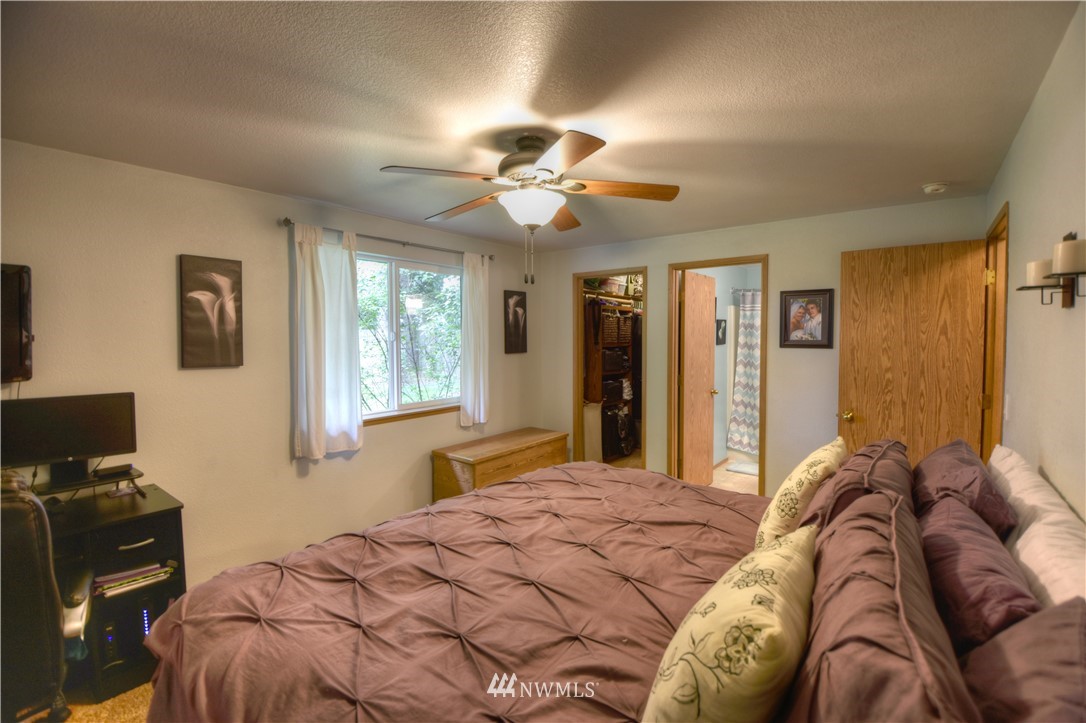 5423 187th Court Southwest Rochester, WA 98579 - Photo 12 of 24 a bedroom with a bed and a tv