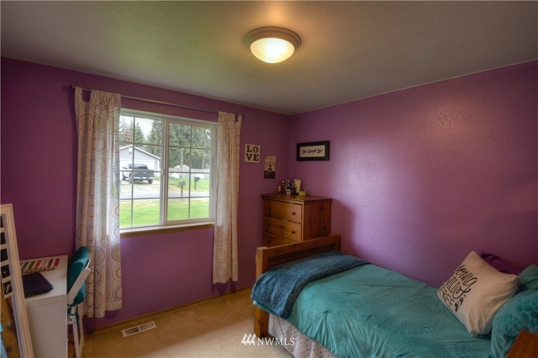 5423 187th Court Southwest Rochester, WA 98579 - Photo 16 of 24 a bedroom with a bed and a window