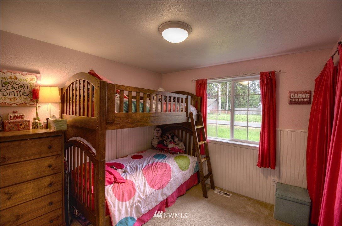 5423 187th Court Southwest Rochester, WA 98579 - Photo 17 of 24 a bed room with a bed and a window