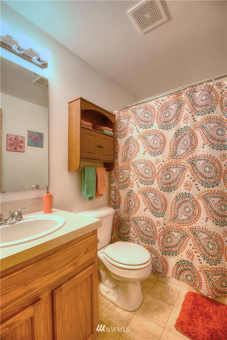 5423 187th Court Southwest Rochester, WA 98579 - Photo 18 of 24 a bathroom with a toilet sink and mirror