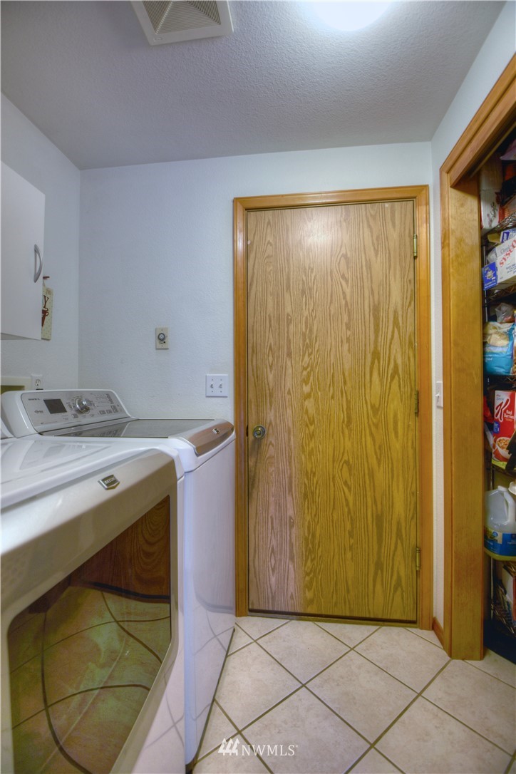 5423 187th Court Southwest Rochester, WA 98579 - Photo 19 of 24 a bathroom with a granite countertop sink and a mirror