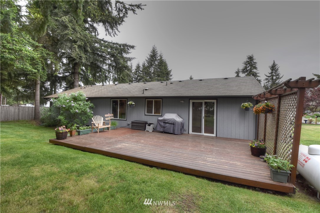 5423 187th Court Southwest Rochester, WA 98579 - Photo 20 of 24 a view of a house with backyard porch and sitting area