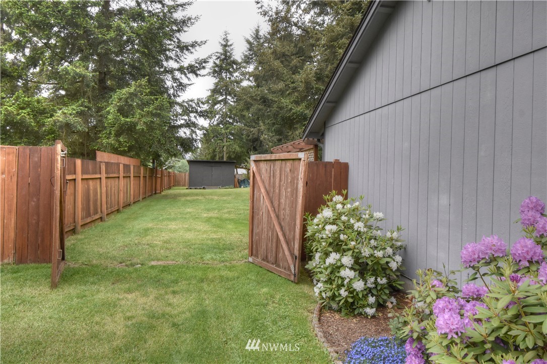 5423 187th Court Southwest Rochester, WA 98579 - Photo 21 of 24 a view of a backyard with a garden