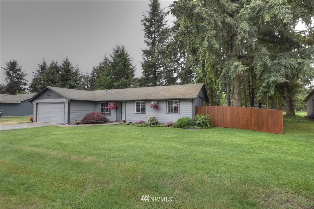 5423 187th Court Southwest Rochester, WA 98579 - Photo 24 of 24 a view of a big house with a big yard and large trees