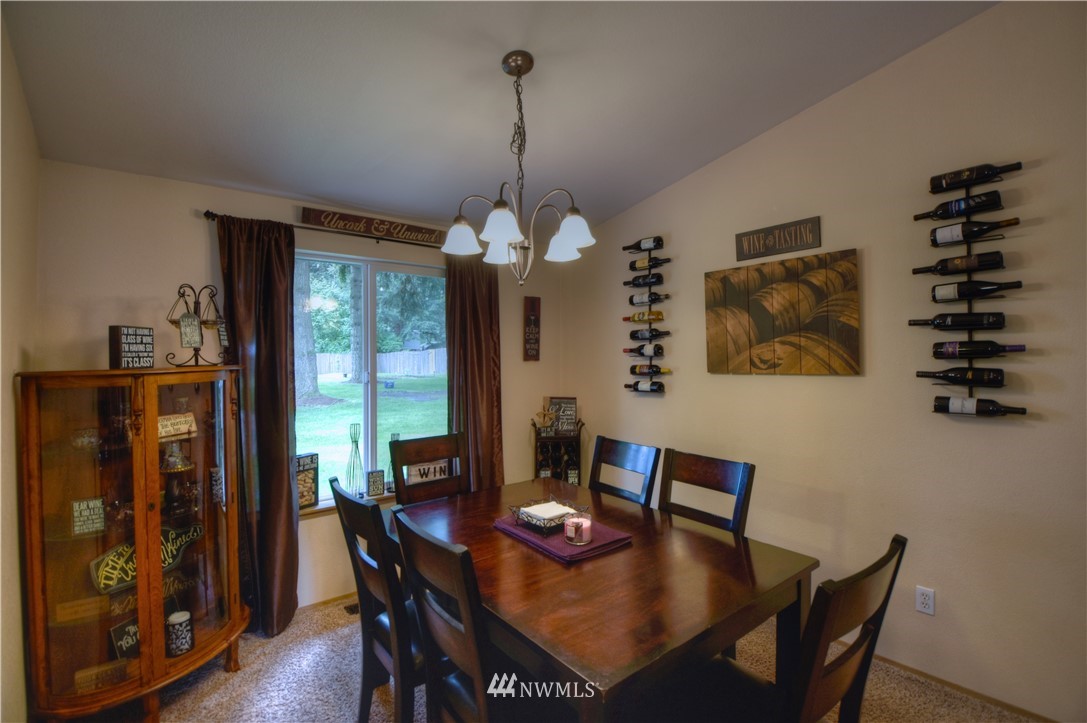 5423 187th Court Southwest Rochester, WA 98579 - Photo 5 of 24 a view of a dining room with furniture window and wooden floor