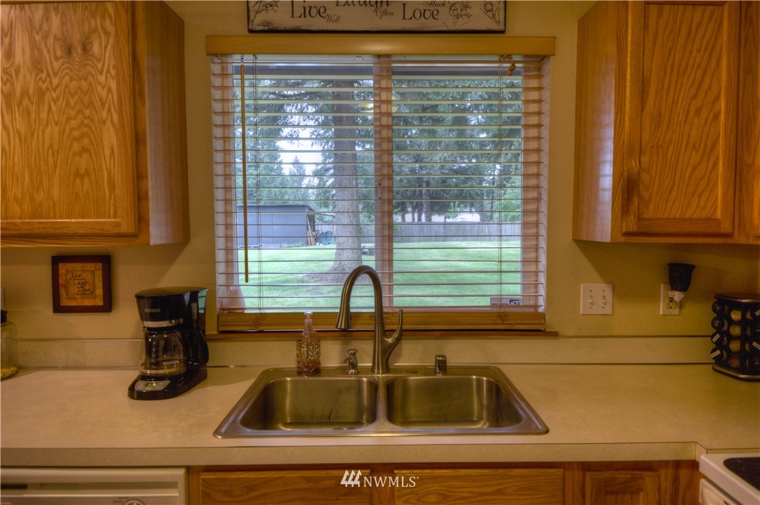 5423 187th Court Southwest Rochester, WA 98579 - Photo 7 of 24 a kitchen with sink and window
