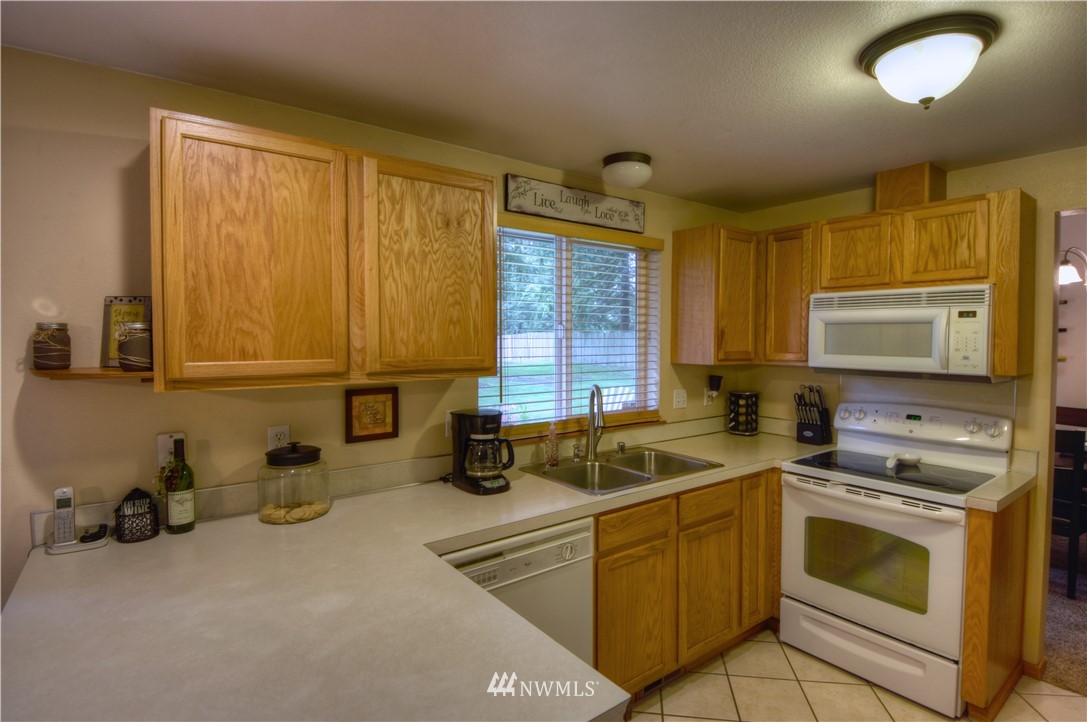 5423 187th Court Southwest Rochester, WA 98579 - Photo 8 of 24 a kitchen that has a sink and a stove top oven