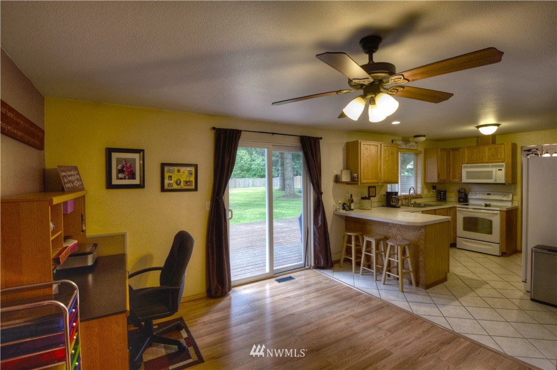 5423 187th Court Southwest Rochester, WA 98579 - Photo 9 of 24 a view of a kitchen with furniture and a ceiling fan