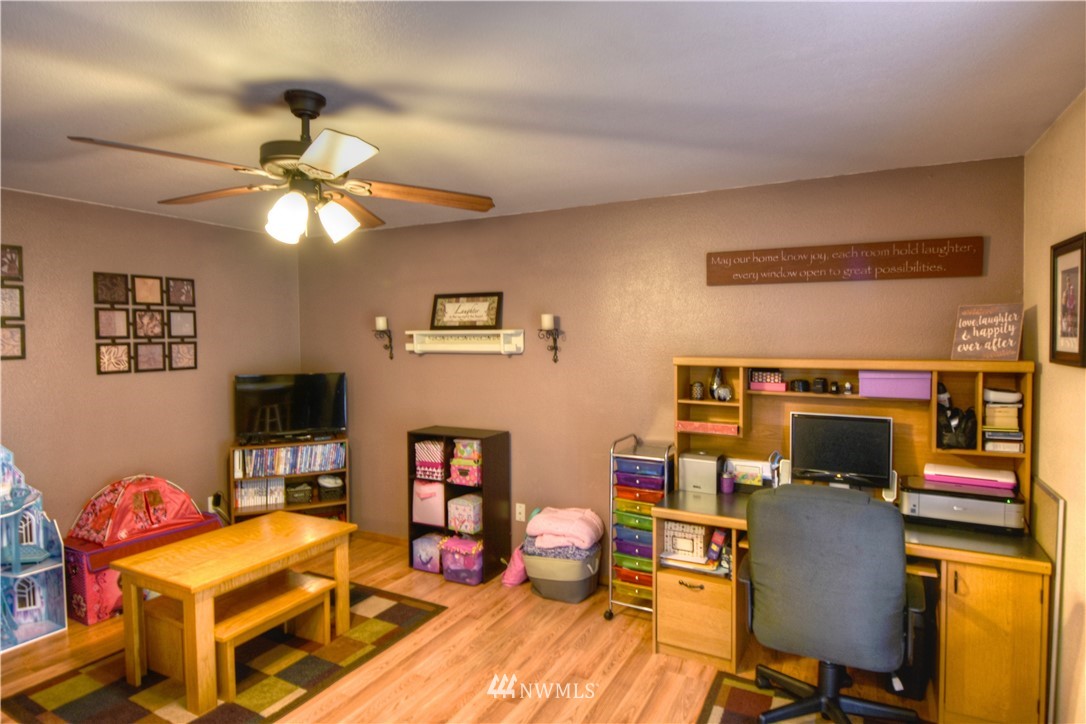 5423 187th Court Southwest Rochester, WA 98579 - Photo 10 of 24 a work room with furniture and wooden floor