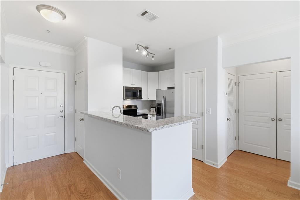 10 Perimeter Summit Boulevard, Unit 4439 Atlanta, GA 30319 - Photo 12 of 69 a view of kitchen with stainless steel appliances a refrigerator and a stove top oven