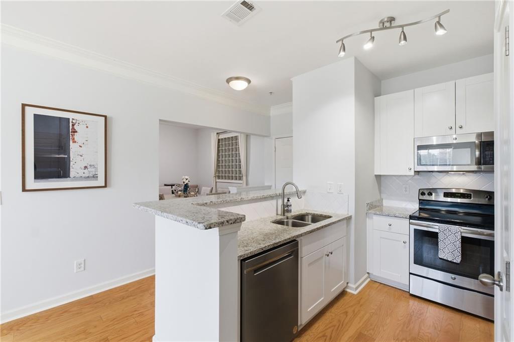 10 Perimeter Summit Boulevard, Unit 4439 Atlanta, GA 30319 - Photo 13 of 69 a kitchen with a sink stove and microwave