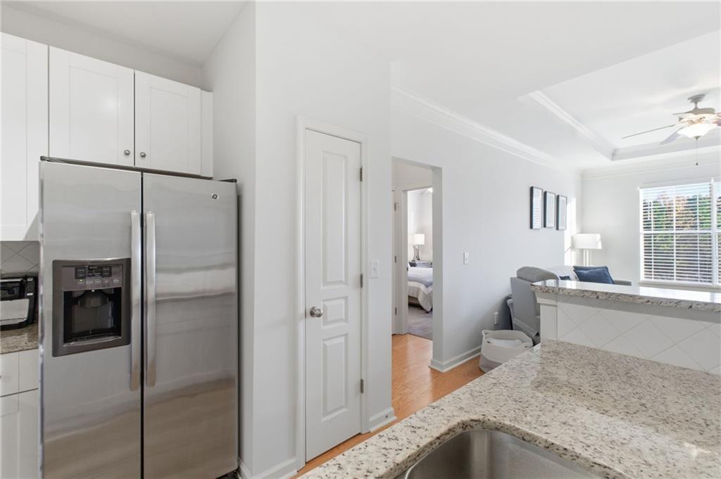 10 Perimeter Summit Boulevard, Unit 4439 Atlanta, GA 30319 - Photo 16 of 69 a kitchen with stainless steel appliances granite countertop a refrigerator and a sink