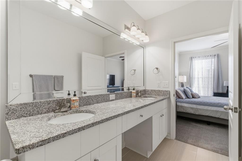 10 Perimeter Summit Boulevard, Unit 4439 Atlanta, GA 30319 - Photo 20 of 69 a en suite bathroom with a granite countertop sink and a mirror