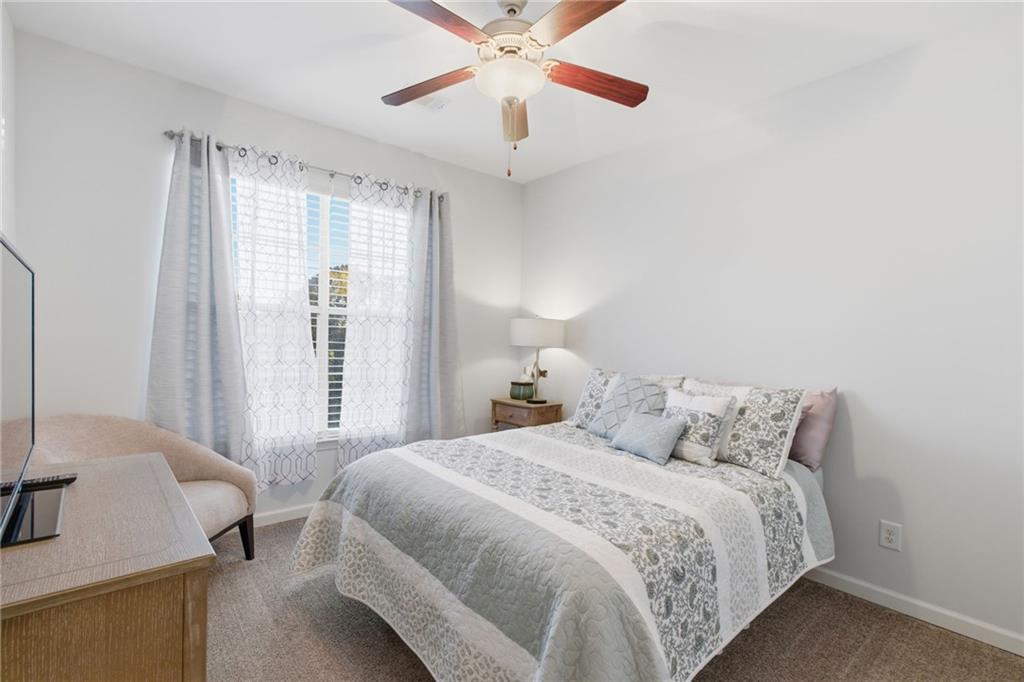 10 Perimeter Summit Boulevard, Unit 4439 Atlanta, GA 30319 - Photo 23 of 69 a bedroom with a bed and a chandelier