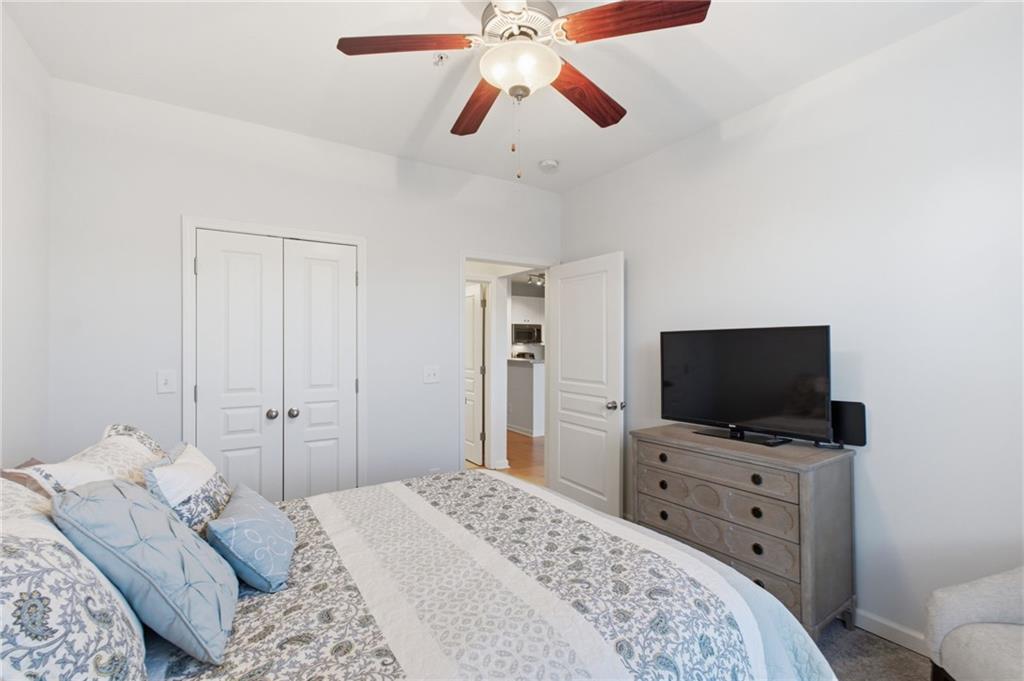 10 Perimeter Summit Boulevard, Unit 4439 Atlanta, GA 30319 - Photo 24 of 69 a bedroom with a bed and a flat tv screen on dresser