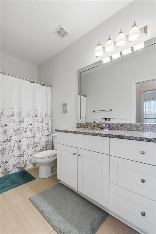 10 Perimeter Summit Boulevard, Unit 4439 Atlanta, GA 30319 - Photo 25 of 69 a bathroom with a sink a toilet and a mirror