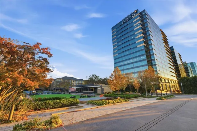 a view of a patio with a table and chairs and floor to ceiling window