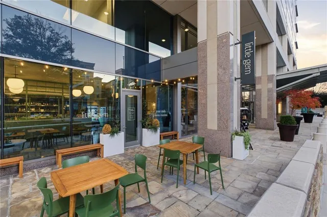 a living room with furniture a chandelier and a floor to ceiling window