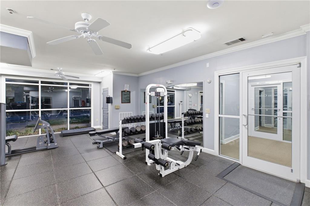 10 Perimeter Summit Boulevard, Unit 4439 Atlanta, GA 30319 - Photo 65 of 69 a living room with furniture a chandelier and a floor to ceiling window