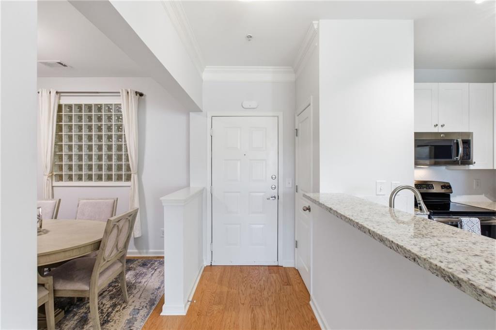 10 Perimeter Summit Boulevard, Unit 4439 Atlanta, GA 30319 - Photo 8 of 69 a bedroom with a bed a table and chair