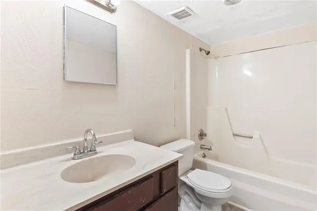 a bathroom with a sink toilet tub and shower