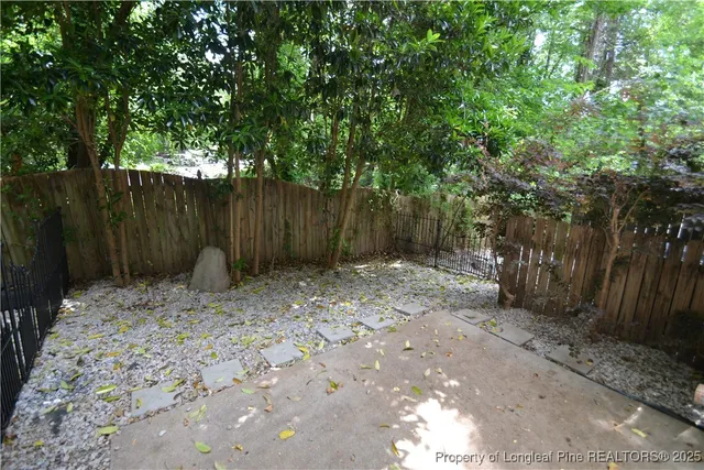 a backyard of a house with lots of plants and trees