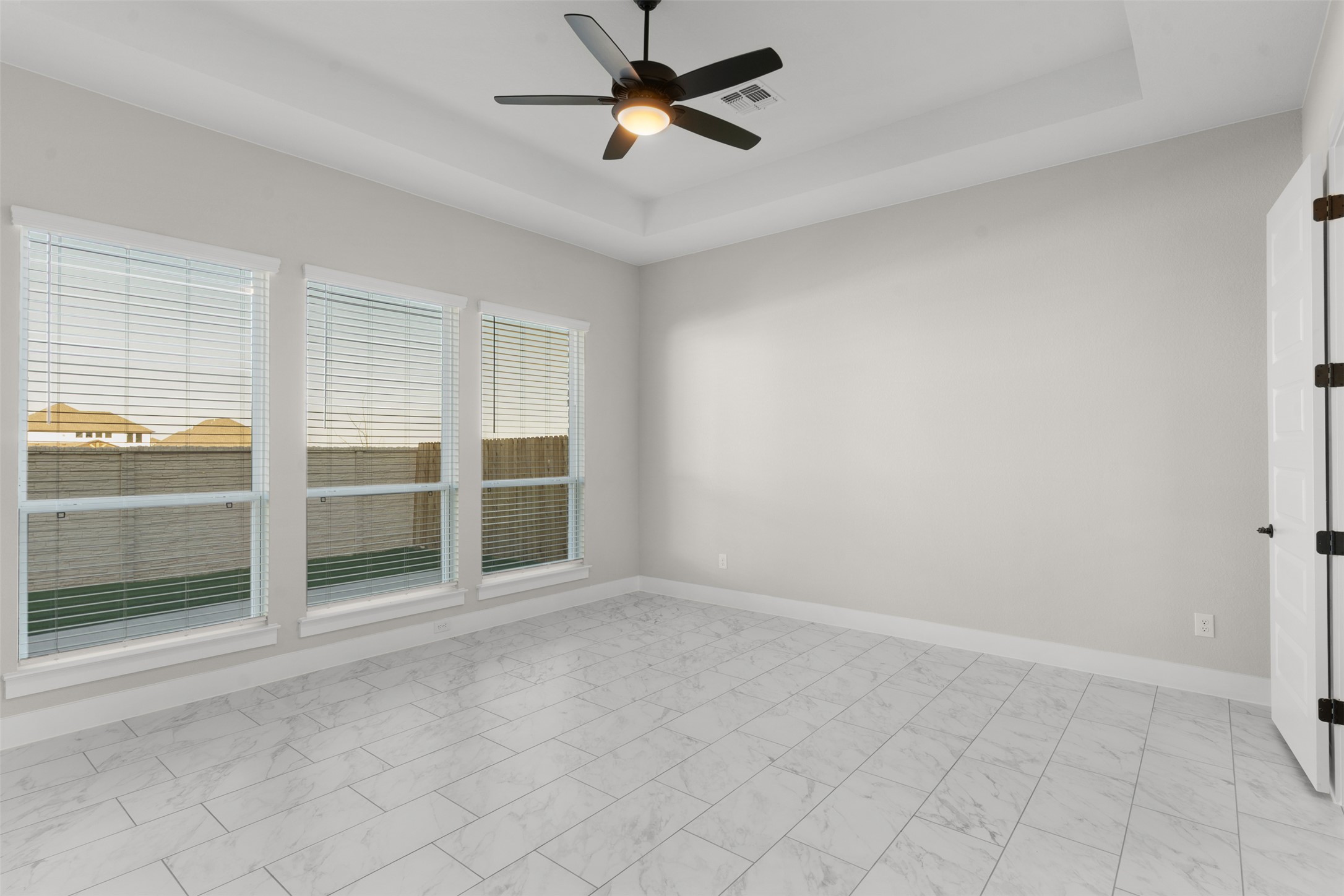 17216 Hope Bergman Road Pflugerville, TX 78660 - Photo 16 of 30 Spare room with a tray ceiling and ceiling fan