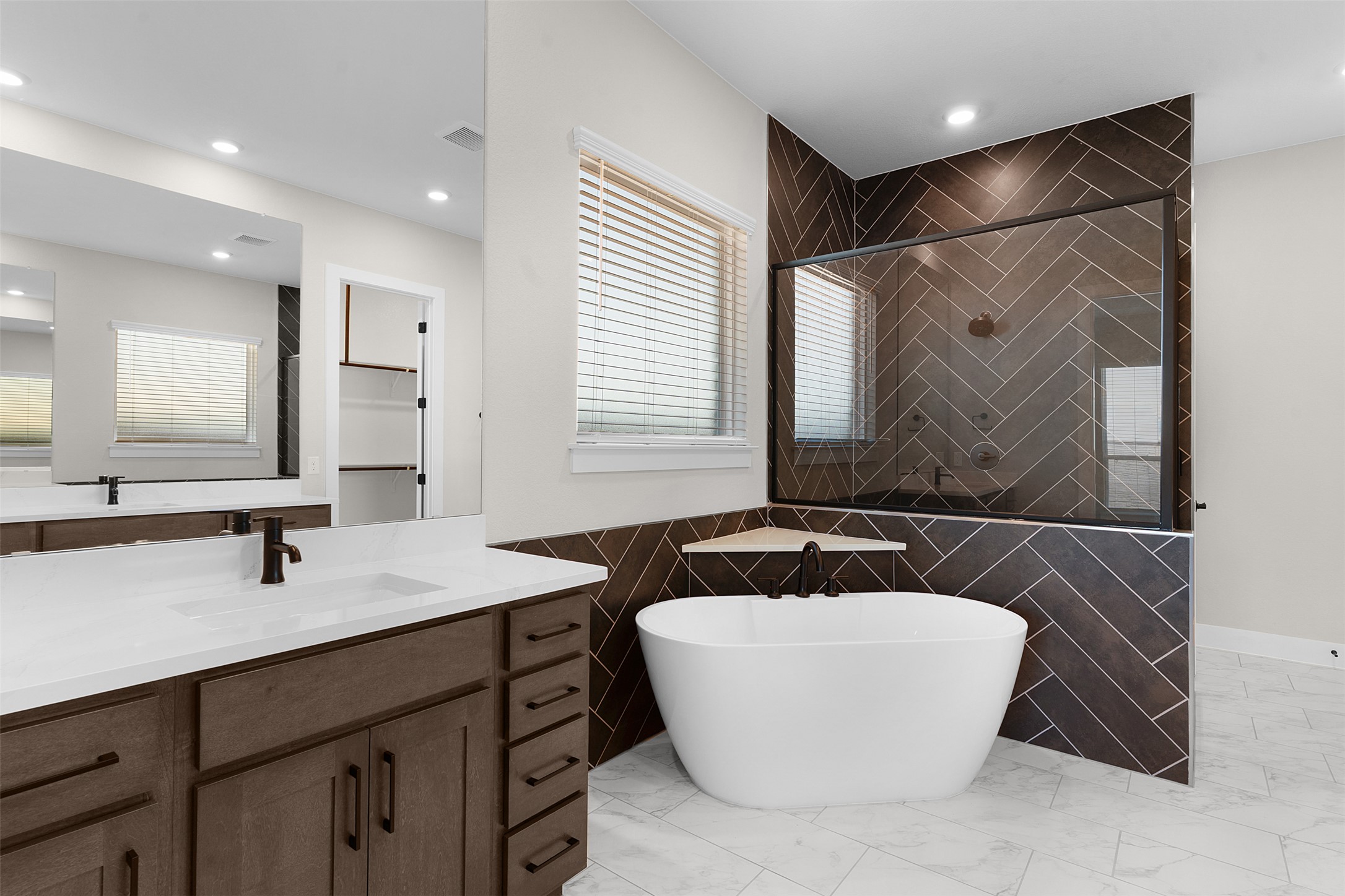 17216 Hope Bergman Road Pflugerville, TX 78660 - Photo 17 of 30 Full bathroom featuring a shower stall, tile walls, vanity, a freestanding tub, and recessed lighting