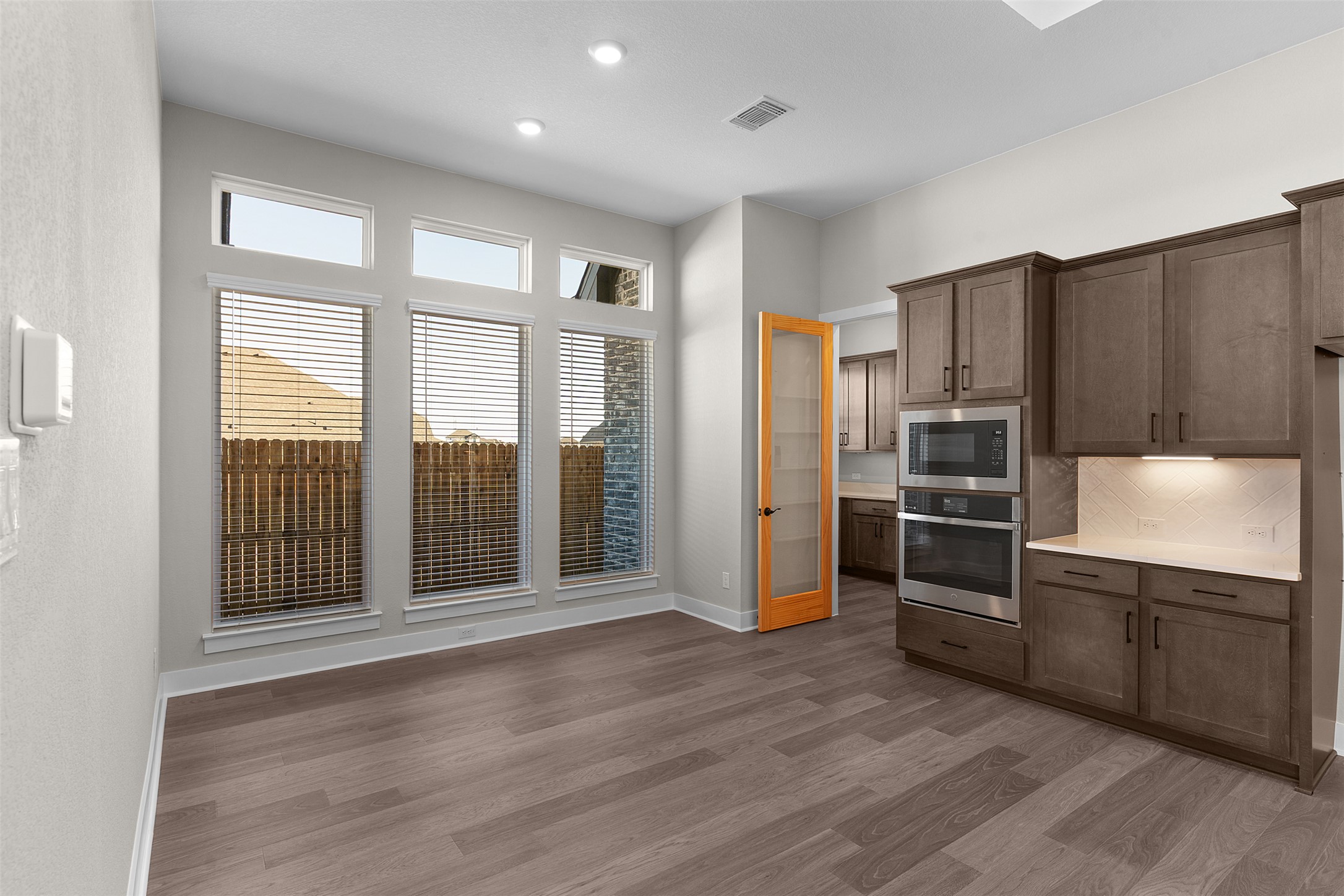 17216 Hope Bergman Road Pflugerville, TX 78660 - Photo 9 of 30 Kitchen featuring appliances with stainless steel finishes, tasteful backsplash, light wood-style floors, and recessed lighting