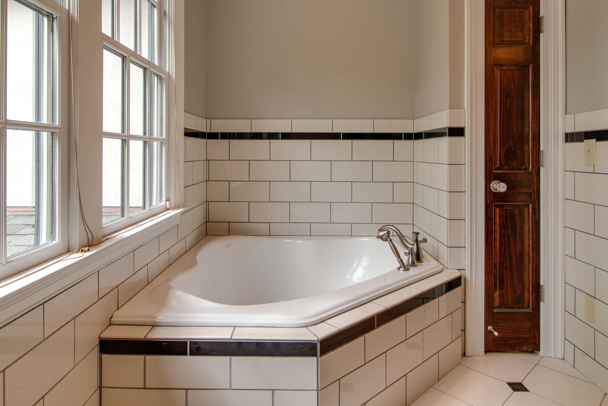 113 Mockingbird Road Nashville, TN 37205 - Photo 23 of 30 a bath tub sitting in a bathroom next to a window