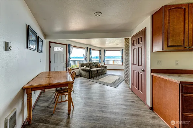 a dining room with furniture and wooden floor