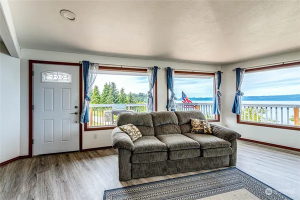a living room with furniture and a floor to ceiling window