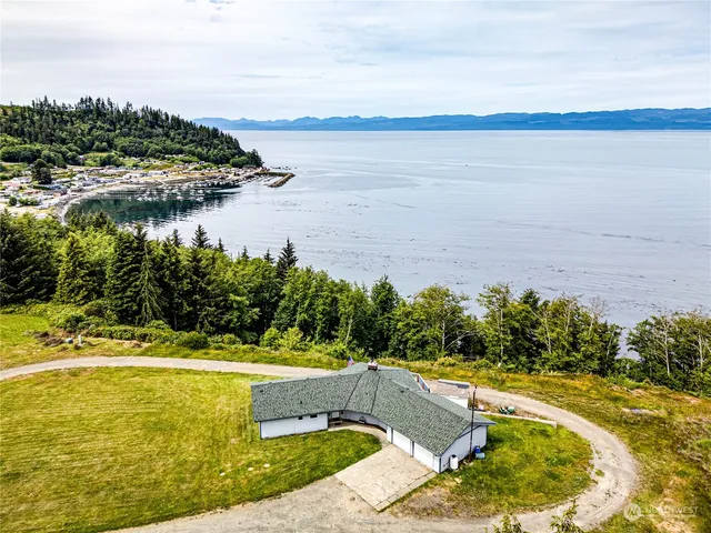 a kitchen with stainless steel appliances granite countertop wooden cabinets a sink and dishwasher with wooden floor
