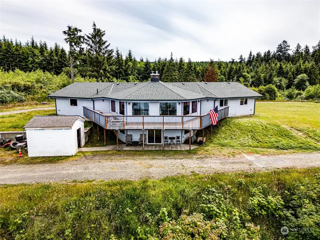 a kitchen with stainless steel appliances granite countertop a sink dishwasher stove and wooden cabinets with wooden floor