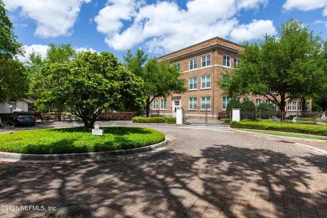 a view of a patio with table and chairs and a large tree