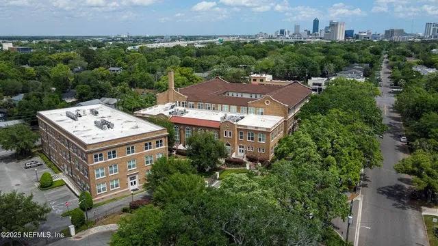 an aerial view of a house with yard