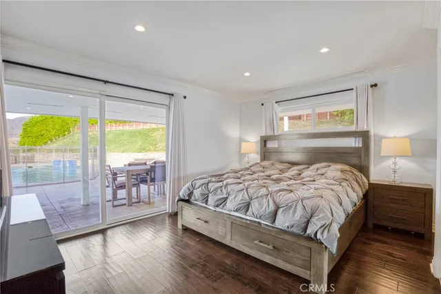 a view of a hallway with wooden floor and furniture