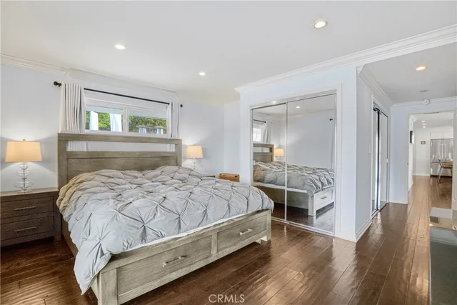 a bed sitting in a spacious bedroom next to a window