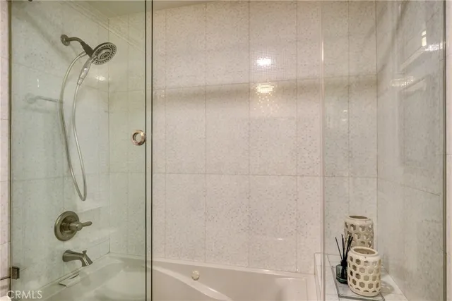 a bathroom with double vanity sinks and a mirror