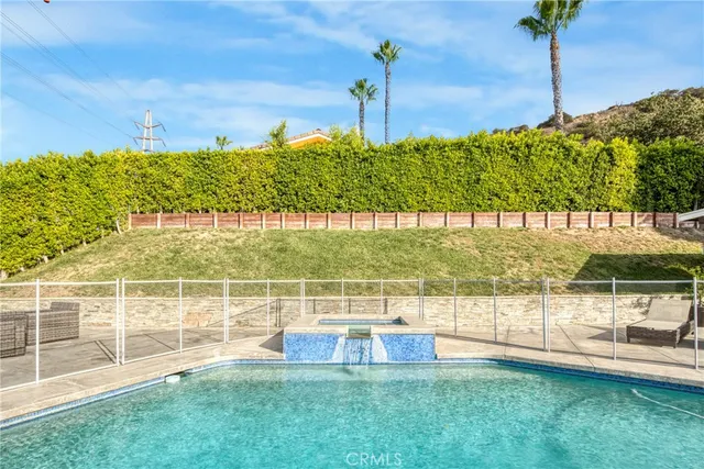 a view of a swimming pool with a lounge chairs