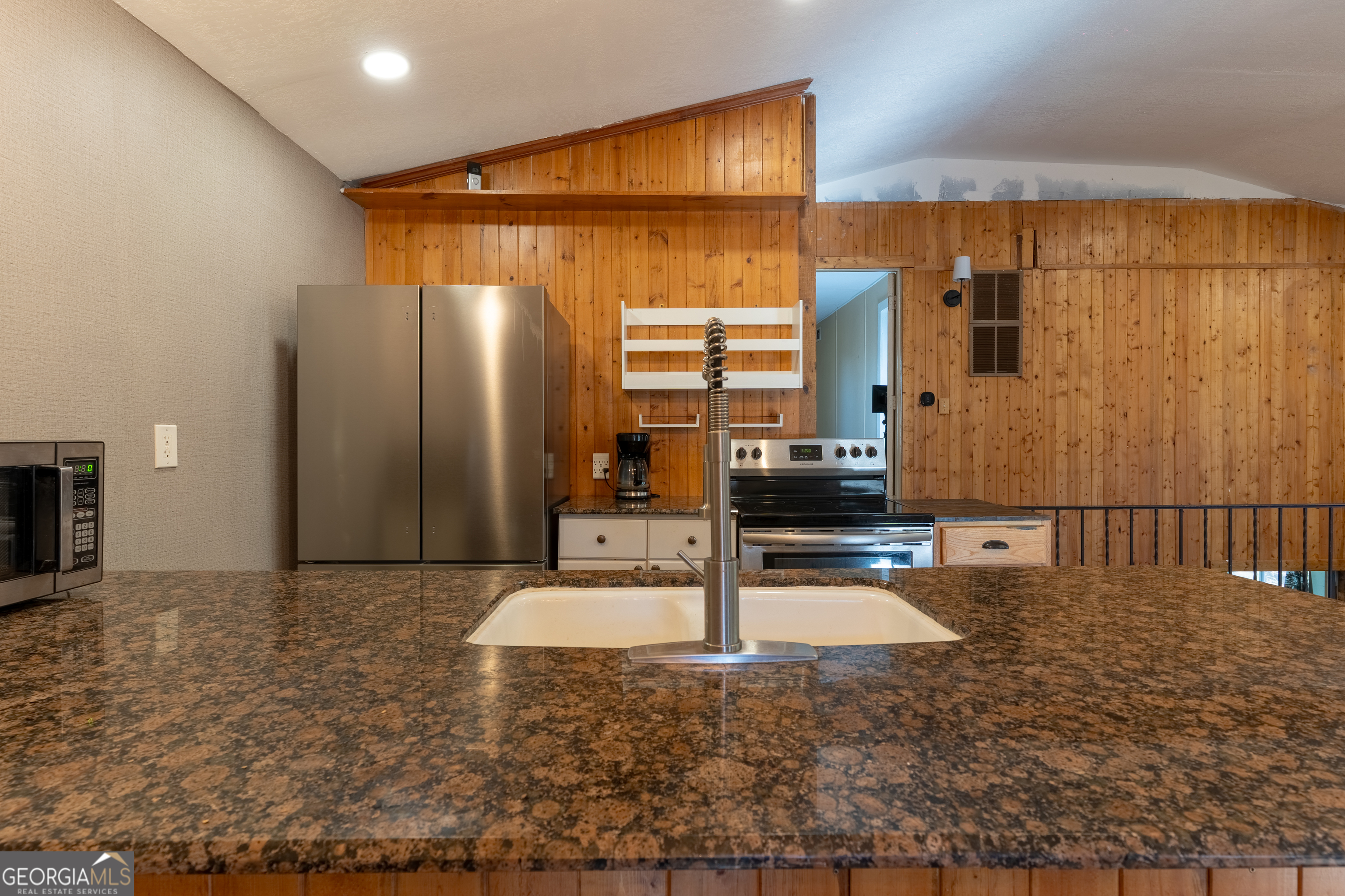 139 Cherokee Drive Jackson, GA 30233 - Photo 11 of 34 a kitchen with stainless steel appliances wooden cabinets a refrigerator and a sink